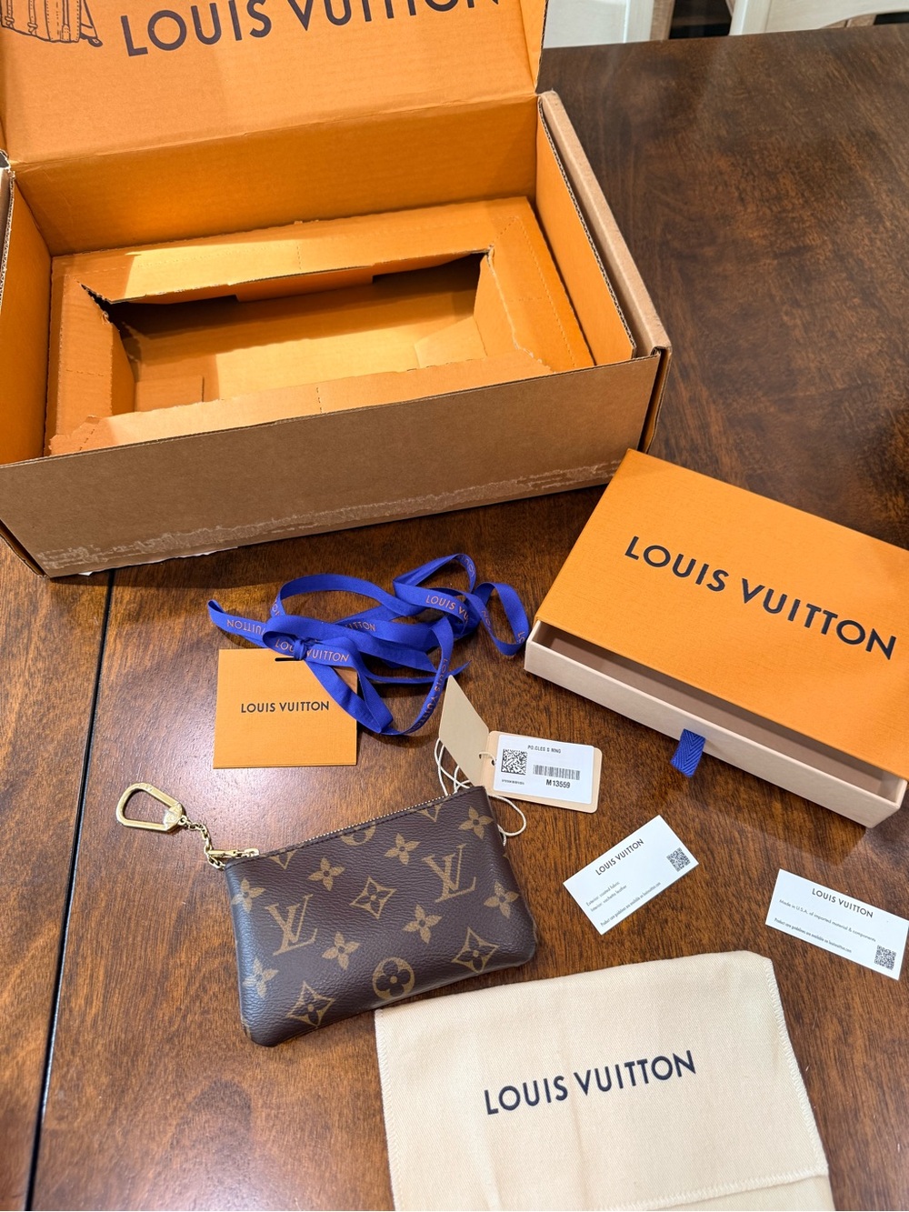 Authentic Louis Vuitton Key Pouch Small Monogram with tags/receipt